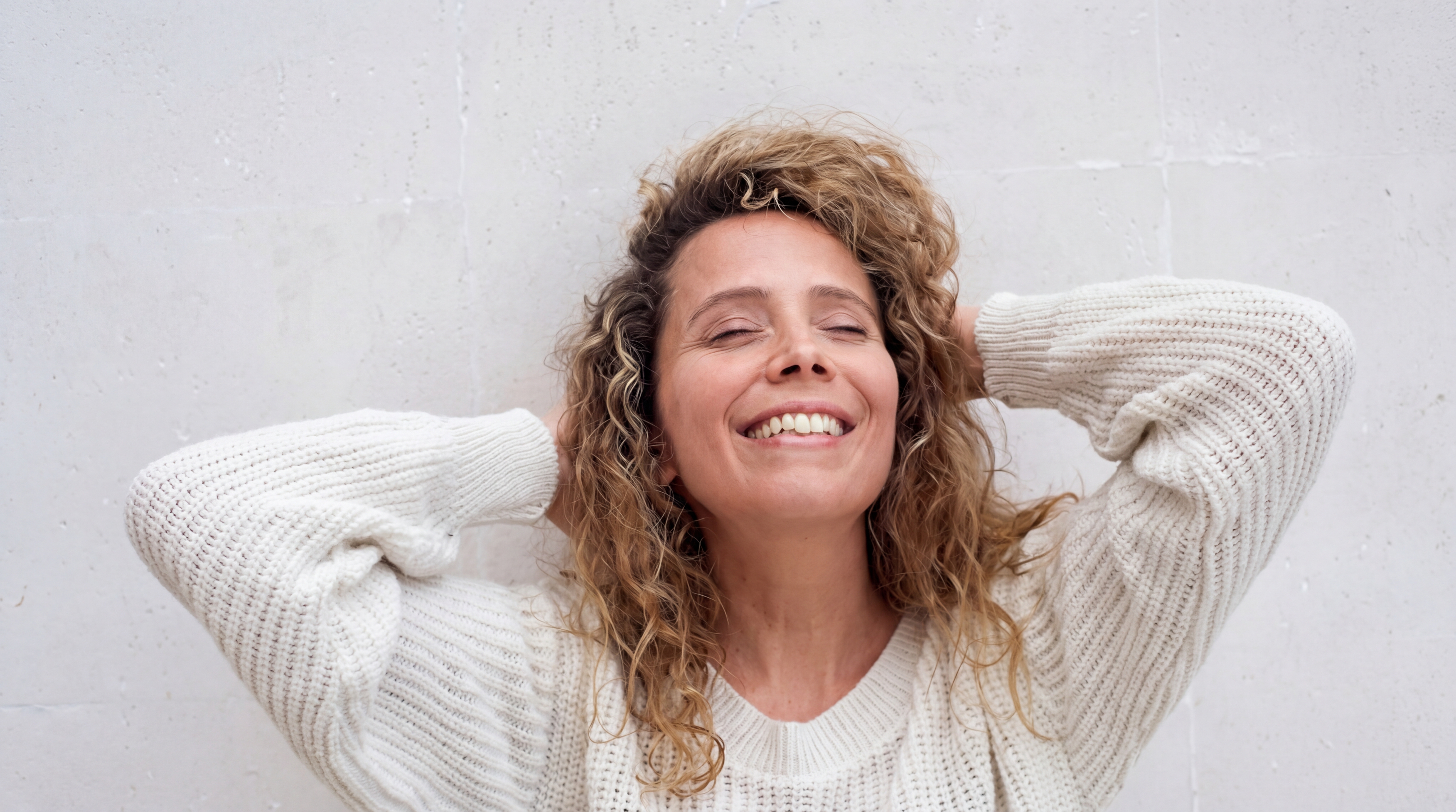 Woman in a moment of contentment — the experience of women is our starting point