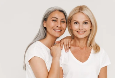 Two women smiling together — diverse representation of women in global health markets